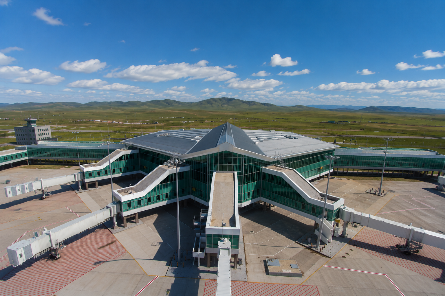 Chinggis Khaan International Airport terminal amid the green hills of Tuv aimag.