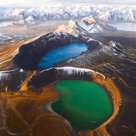 Blue and green lakes surrounded by steep rocky slopes in the Ikh Bogd mountains.